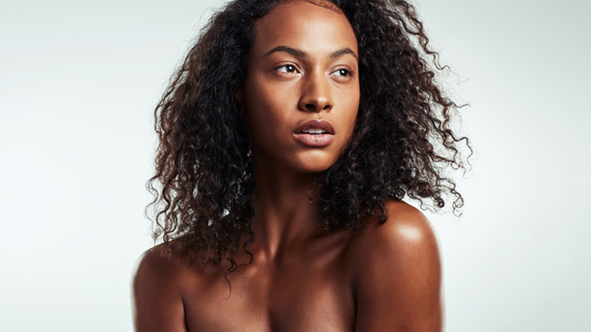 A close-up face portrait of a black woman smiling