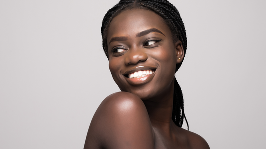 Portrait of Beautiful african woman with dark hair, fresh glowing skin face and bare shoulders isolated on white